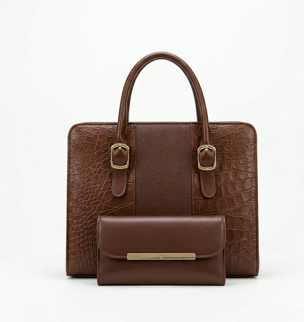Brown crocodile-patterned handbag with matching wallet on a white background
